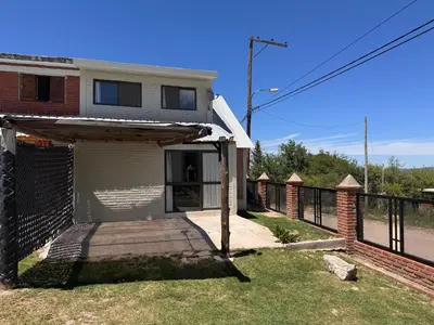 a house with a porch and a fence at Monte Loft in Mina Clavero