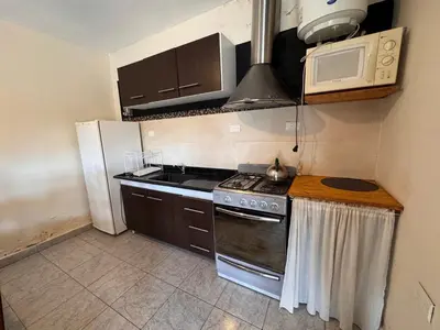 a kitchen with a stove and a microwave at Monte Loft in Mina Clavero
