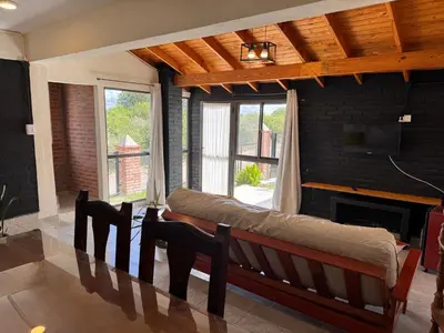 a living room with a couch and a fireplace at Monte Loft in Mina Clavero