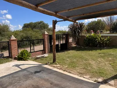 an open gate in a park with a fence at Monte Loft in Mina Clavero