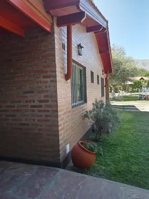a brick building with a planter on the side of it at Los Estribos Merlo in Merlo