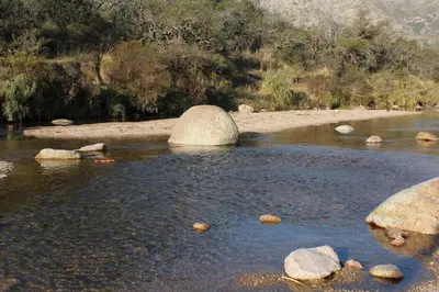 a pool of water with rocks in a river at Cabañas 
