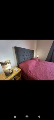 a bedroom with a bed and a table with a chair at Manzanillas in Mina Clavero