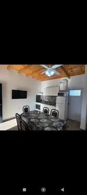 a kitchen with a table with chairs and a ceiling fan at Manzanillas in Mina Clavero