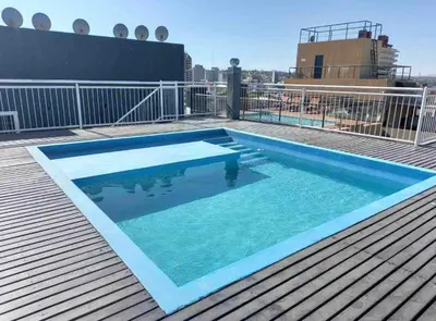 a swimming pool on the roof of a building at Finlay Departamento in Villa Carlos Paz