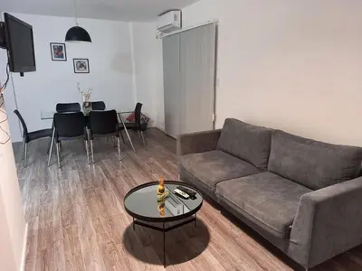 a living room with a couch and a table at Finlay Departamento in Villa Carlos Paz