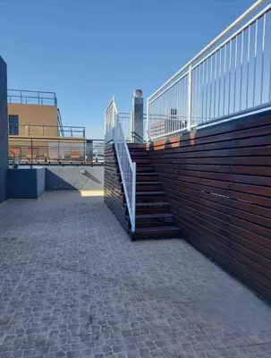 a set of stairs with a railing on a building at Finlay Departamento in Villa Carlos Paz