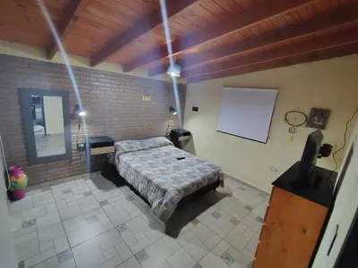 a bedroom with a bed in a brick wall at Cabañas mauro in Tanti