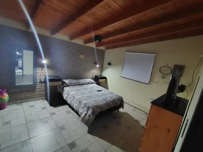 a bedroom with a bed in a brick wall at Cabañas mauro in Tanti
