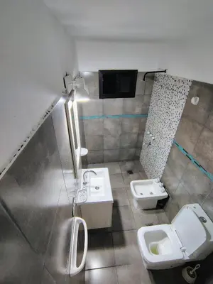 a bathroom with two sinks and two toilets in it at Cabañas mauro in Tanti