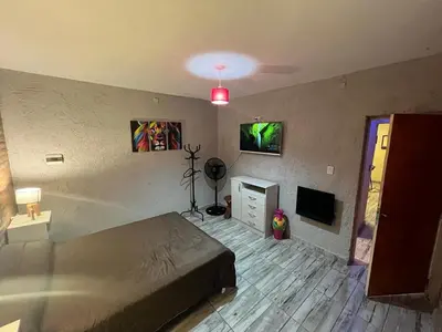 a bedroom with a bed and a tv in it at Cabañas mauro in Tanti