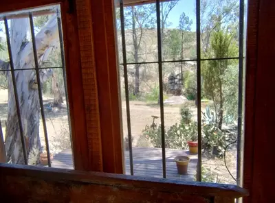 an open window with a view of a yard at Cabaña Tanti Estancia La Escondida in Tanti
