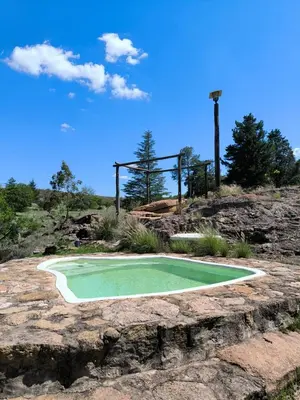 a small green golf hole on top of a hill at Cabaña Tanti Estancia La Escondida in Tanti