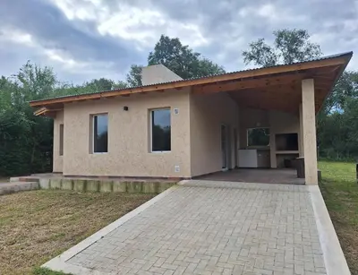 a small house with a large driveway in front of it at Casa Rincon in Villa General Belgrano