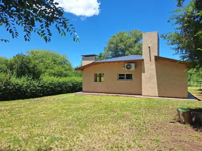 a house on a hill with a grassy yard at Casa Rincon in Villa General Belgrano