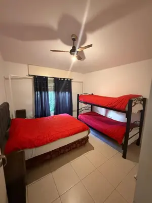 a bedroom with two beds and a ceiling fan at Cabaña kempes Córdoba in Cordoba