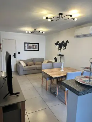 a living room with a couch and a table at Departamento Nueva Córdoba in Cordoba