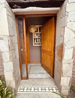 an entrance to a building with a wooden door at La Chascona Suite in Merlo