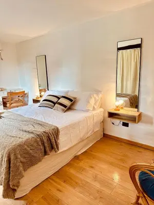 a bedroom with a large bed and a window at La Chascona Suite in Merlo