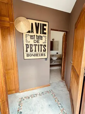 a bathroom with a sign on the wall at La Chascona Suite in Merlo
