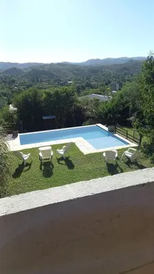a swimming pool with four chairs and a table at Alojamiento en Villa La Bolsa in La Bolsa