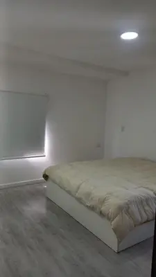 a bedroom with a bed in a white room at Alojamiento en Villa La Bolsa in La Bolsa