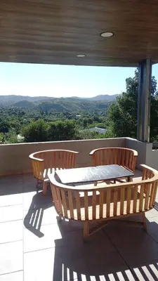two chairs and a table on a balcony with a view at Alojamiento en Villa La Bolsa in La Bolsa