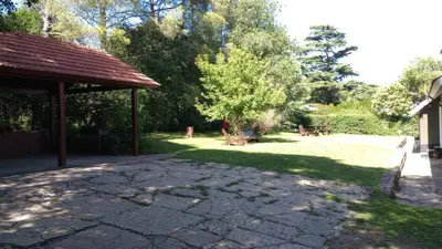 a garden with a pavilion and a patio at Liquidambar in Villa General Belgrano