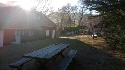 a picnic table sitting in the grass next to a house at Liquidambar in Villa General Belgrano