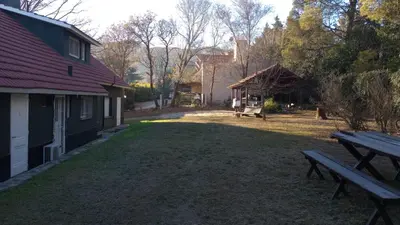 a picnic bench in a yard next to a building at Liquidambar in Villa General Belgrano