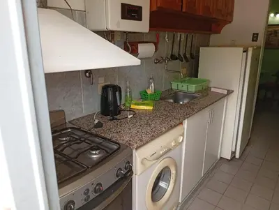 a kitchen with a sink and a washing machine at Alojamiento Lo de Jaime in Merlo