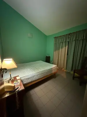 a bedroom with a bed and a desk with a lamp at Alojamiento Lo de Jaime in Merlo