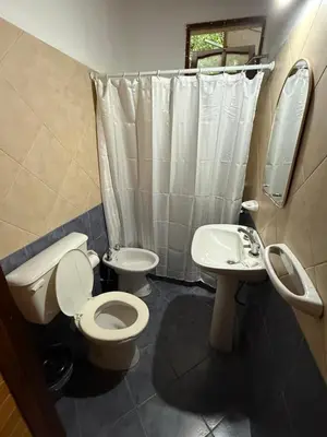 a bathroom with a toilet and a sink at Cabañas La Cautiva in Tanti