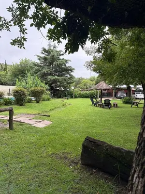 a park with picnic tables and a gazebo at Cabañas La Cautiva in Tanti