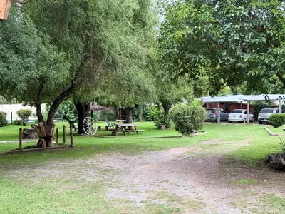 a park with a picnic table and a tree at Cabañas La Cautiva in Tanti