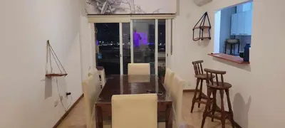 a dining room with a wooden table and chairs at Departamento Lugones Nva Córdoba in Cordoba