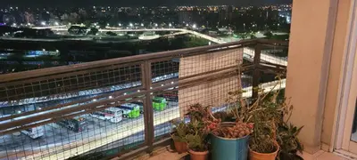 a balcony with potted plants and a view of a city at Departamento Lugones Nva Córdoba in Cordoba