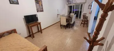 a living room with a couch and a television and a table at Departamento Lugones Nva Córdoba in Cordoba