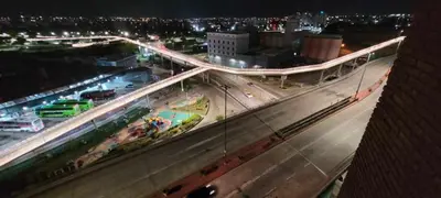 a bridge over a highway in a city at night at Departamento Lugones Nva Córdoba in Cordoba