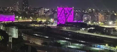 a view of a city at night with purple lights at Departamento Lugones Nva Córdoba in Cordoba
