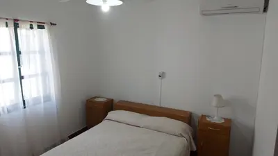 a small bedroom with a bed and a window at Castillo Del Lago Hospedaje Compartido in Villa Carlos Paz