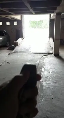 a persons hand pointing at a room with a garage at Castillo Del Lago Hospedaje Compartido in Villa Carlos Paz