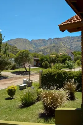a garden with plants and mountains in the background at Casa Almendro-Chumamaya-Villa de Merlo in Country Club Chumamaya
