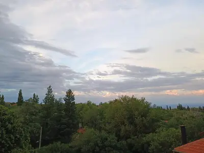 a view of a forest of trees under a cloudy sky at Casa Almendro-Chumamaya-Villa de Merlo in Country Club Chumamaya