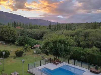 a swimming pool with a view of the mountains at Casa Almendro-Chumamaya-Villa de Merlo in Country Club Chumamaya