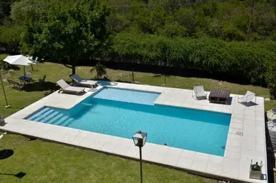 an overhead view of a large swimming pool with chairs at Casa Almendro-Chumamaya-Villa de Merlo in Country Club Chumamaya
