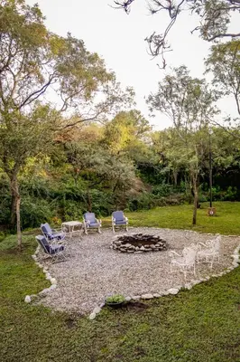 a group of chairs and a fire pit in a yard at La Tranquilidad in Merlo