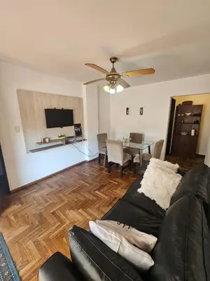 a living room with a couch and a dining table at Mamina Apartamento in Cordoba