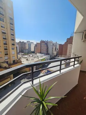 a plant on a balcony with a view of a city at Mamina Apartamento in Cordoba