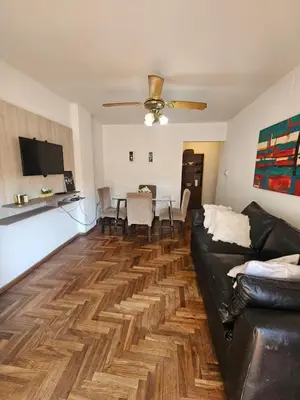 a living room with a black couch and a table at Mamina Apartamento in Cordoba